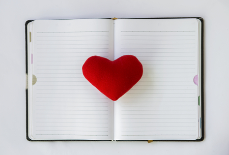 Love note, red heart on blank notebook, valentine conceptの写真素材