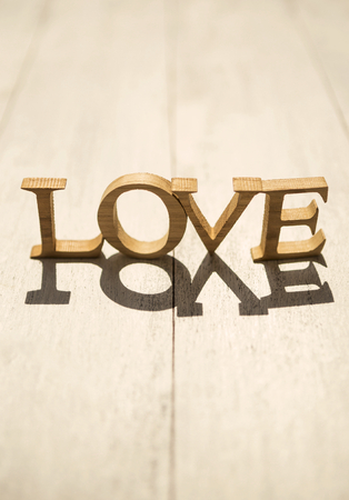 Love background, wooden love on wood background with morning lightの写真素材