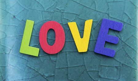 Colorful wooden love on crack glass texture backgroundの写真素材