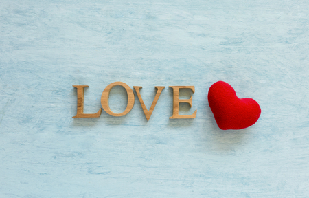 Wooden love text and red heart over blue texture backgroundの写真素材