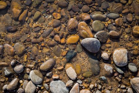 Natural background of round pebble stone on the beachの写真素材