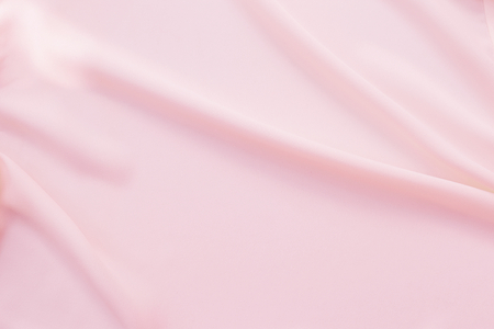 Abstract waving pink fabric texture backgroundの写真素材