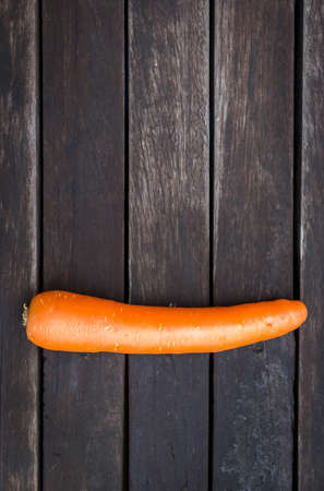 Fresh carrot on dark wooden backgroundの写真素材