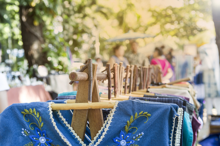 New dress hanging on wooden hanger at Outdoor market in Thailand, fashion business conceptの写真素材