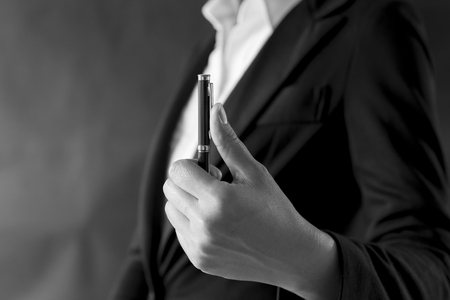 Abstract business concept background of business girl holding pen, vintage black and white toneの写真素材