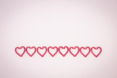 Abstract valentine concept background, red heart arrange on vintage pink paper texture background,...