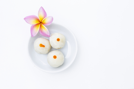 Chinese pastry filled with mung bean paste, Thai snack in white plate decorate with plumeria flowerの写真素材