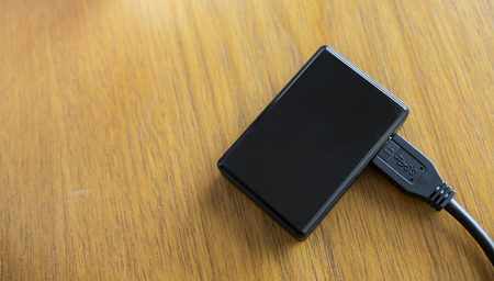 Black mini usb hub on wooden table background, technology conceptの写真素材