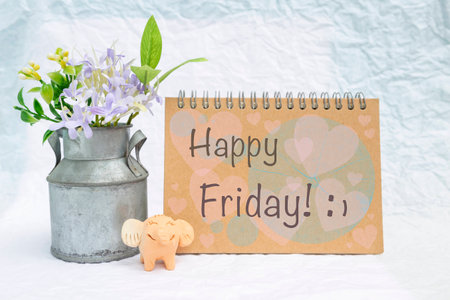 Happy Friday card with happy elephant clay and tin flower pot over blurred white backgroundの写真素材