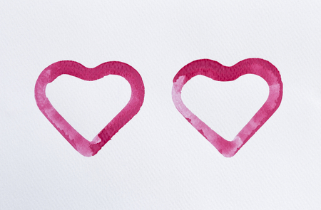 Watercolor paint in red heart shape on white paper texture background, heart symbol, love and valentine concept backgroundの写真素材