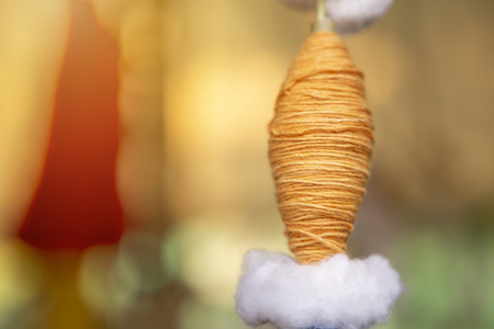 Closeup orange cotton thread over blurred background, selective focus, decoration objectの写真素材