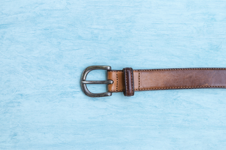 Old leather men belth on blue texture background, man fashion objectの写真素材