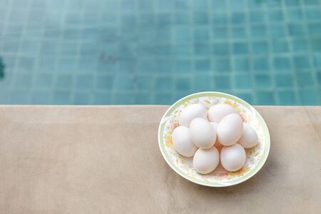 Duck eggs on swimming pool edge, happy egg, healthy life style, healthy food