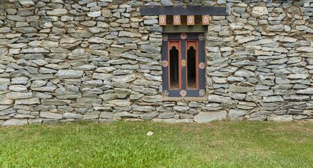 Desig wall window in stone wall, house wall design idea with wooden window designの写真素材