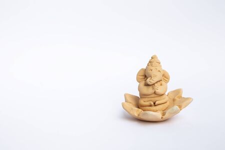 Handmade cute little elephant caly isolate on white background, handmade clay ganesha on lotus flowerの写真素材