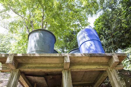 Water storage in the remote area in Thailand, plastic water container on cement foundation in the forestの写真素材