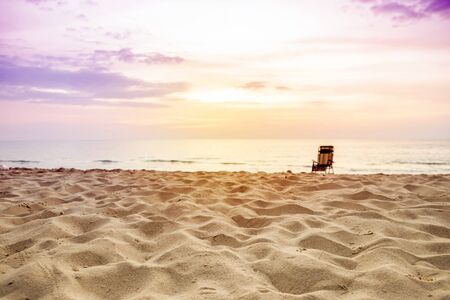 Sunset at the beach, relaxing and peaceful view, beach chair on the sand