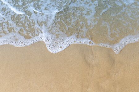 White wave on brown sand beach, nature background, outdoor day light
