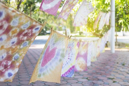 Natural tie dye cloth hanging to dry, colorful design cloth, art of cloth tie dyeの写真素材