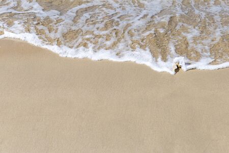 White wave on empty clean sand beach, nature concept background, summer outdoor day light