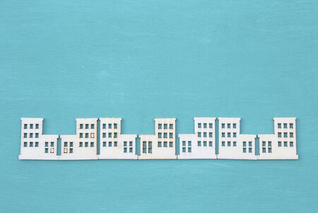 Wood cut in building shape on blue texture background, craft design object, decorate itemの写真素材