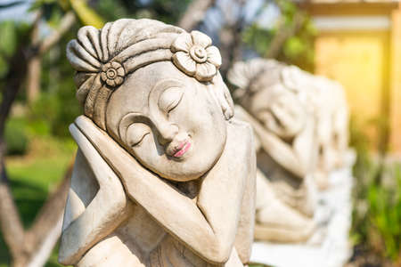 Balinese girl sculpture, garden decoration object, outdoor day light