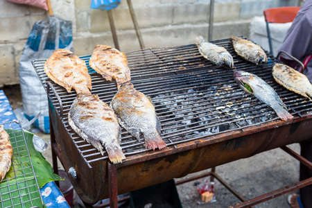 Grill fish at food market in Thailand, Thai style grill fish filled with herbsの写真素材
