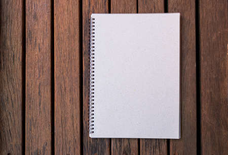 Blank notebook on old wood background, education or object concept vintage style, outdoor day light