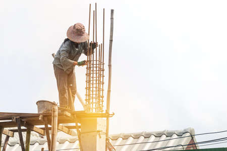 Female labor working at concstruction site, girl building house, work safety, construction business