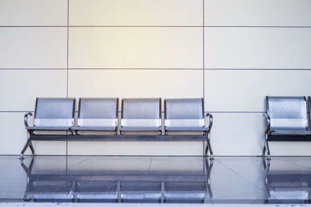 modern aluminum bench with space on empty wall background, waiting are of the office building, furniture design ideaの写真素材