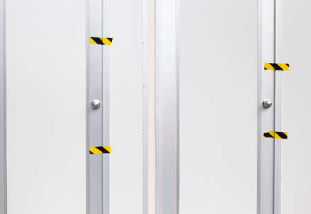Blank white wall and door background, control room with sticker on whte door, no entry area