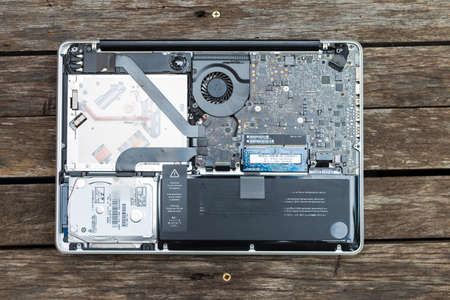 Inside laptop computer on wood background, fixing hard disk and upgrade computer system, technology...