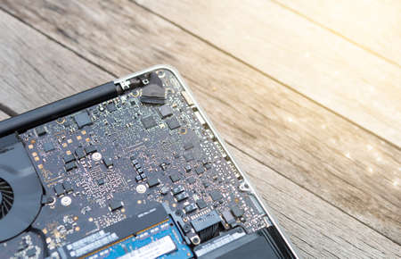 Inside laptop computer on wooden floor background, computer repair service, new technology and...