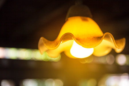 Closeup vintage style ceiling lamp in old wooden house, power and energy concept, electricity, lighting designの写真素材