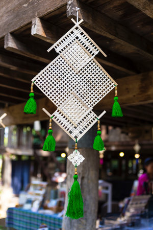 Beautiful handmade bamboo wood mobile with green cotton thread, Northern Thai style handicraft, Thai style house decorationの写真素材