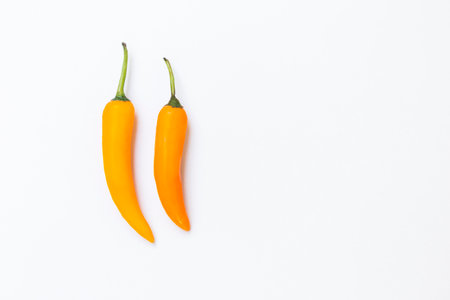 Yellow chilli on white background, mild spicy symbol for Thai foodの写真素材