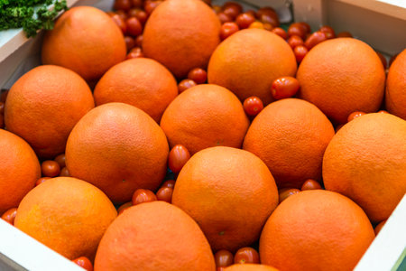 Grapefruit with cherry tomato in wooden box, healthy and diet food conceptの写真素材