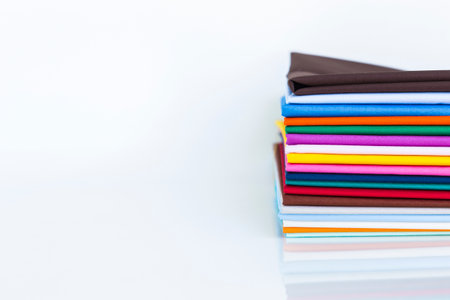 Pile of colorful cotton fabric with space on white background, textile industry concept backgroundの写真素材