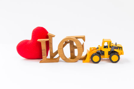 Yellow truck moving wooden love and red heart, love clearance, valentine concept background