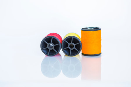 Colorful thread spool on white background, sewing thread, craft toolの写真素材