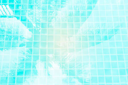 Abstract water texture background, coconut tree shadow on swimming pool water, tropical and summer concept background, vintage tone styleの写真素材