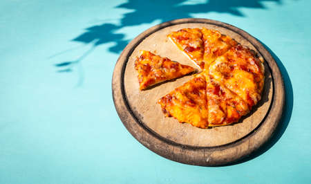 Home made pizza on old round wooden cutting board with morning day light, Homemade margarita pizza