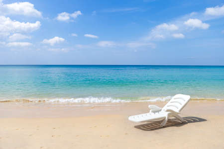 White plastic beach chair on tropical beach, relax by the sea, summer outdoor day light, outdoor furnitureの写真素材