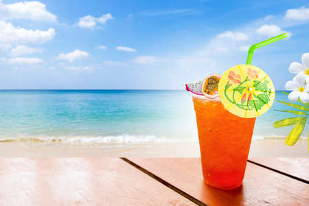 Tropical fruit ice tea on the beach, summer drinkの写真素材