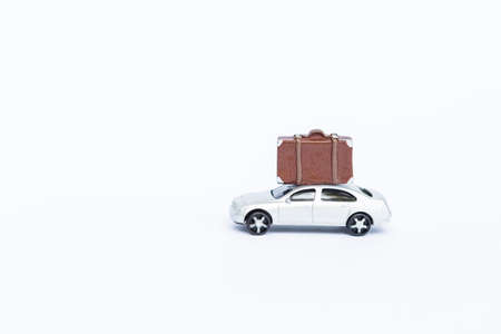 Model car with luggage toy isolate on white background, travel insurance conceptの写真素材