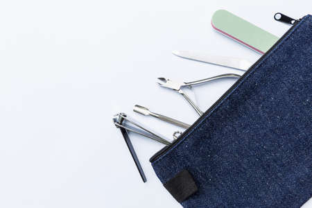 Nail tool kit in blue bag isolate on white background, manicure equipment, nail care