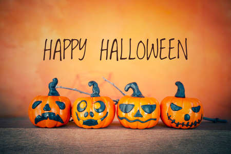 Happy Halloween greeting card idea, Funny Halloween pumpkin collections over blurred orange background, Halloween decoration itemの写真素材