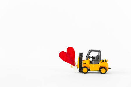 Forklift truck with red heart isolate on white background, carry love, valentine concept backgroundの写真素材