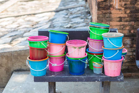 Colorful plastic bucket and basket stack, dirty plastic container, environmental conceptの写真素材