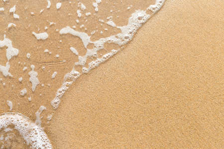 Closeup sandy beach background, fine sand with white wave, nature background, summer outdoor day...